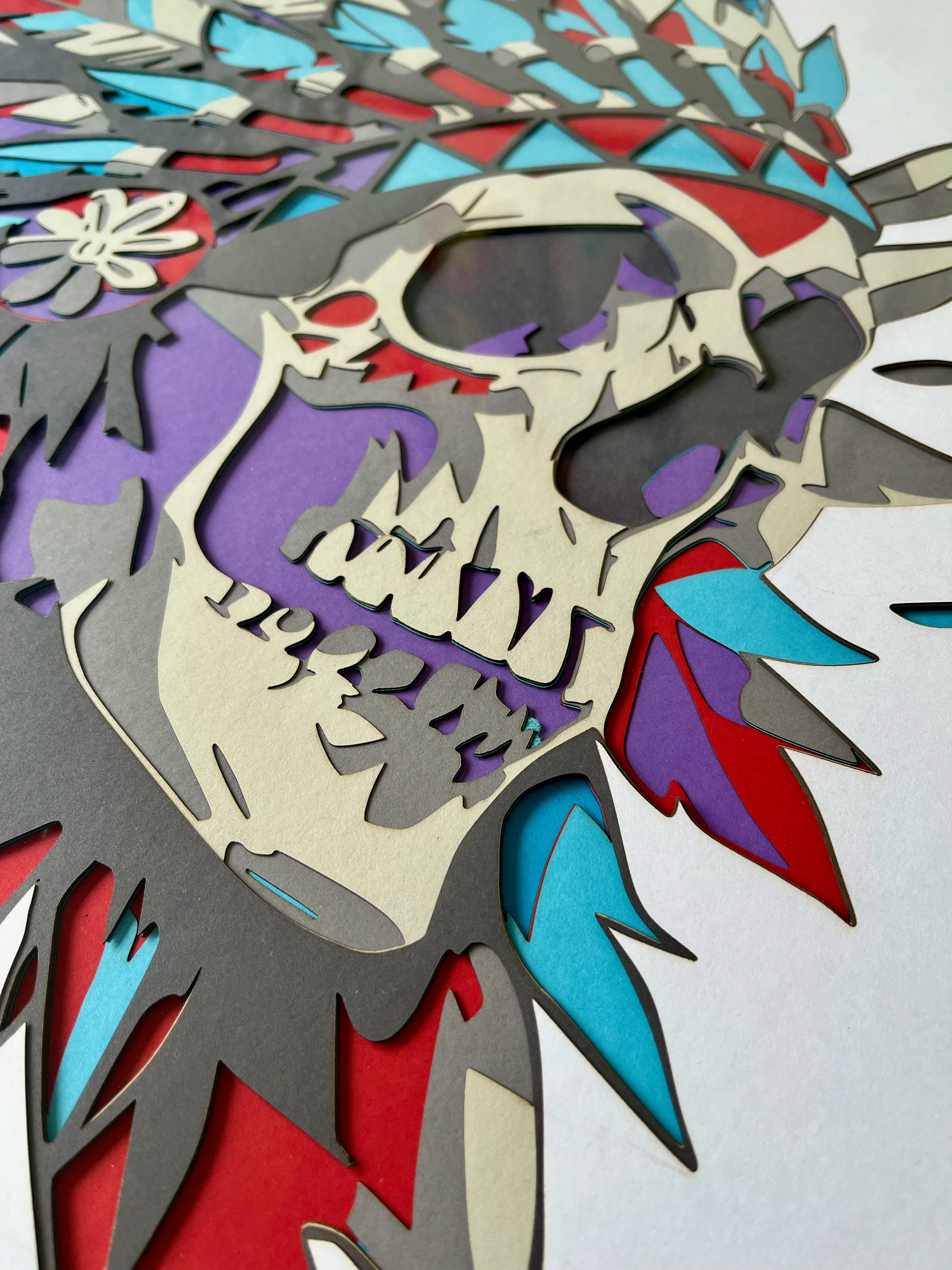 Crâne avec plumes indiennes encadré 70x70cm